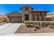 Inviting single-Gathering home with manicured landscaping, a two car garage and decorative front door at 13641 W Jesse Red Dr, Peoria, AZ 85383