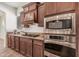 Modern kitchen featuring granite countertops, stainless appliances, and wood cabinets at 13641 W Jesse Red Dr, Peoria, AZ 85383