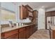 Kitchen featuring granite countertops, wood cabinets, and stainless appliances at 13641 W Jesse Red Dr, Peoria, AZ 85383