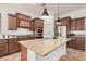 Modern kitchen with a granite island, stainless steel appliances and wood cabinets at 13641 W Jesse Red Dr, Peoria, AZ 85383