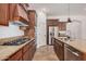 Modern kitchen with granite counters, stainless appliances, wood cabinets, and gas cooktop at 13641 W Jesse Red Dr, Peoria, AZ 85383