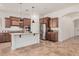 Gourmet kitchen features stainless appliances, granite counters, tile floors, and center island at 13641 W Jesse Red Dr, Peoria, AZ 85383