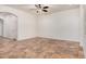 Open floor plan with neutral walls, tile flooring and a ceiling fan at 13641 W Jesse Red Dr, Peoria, AZ 85383