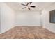 Open floor plan with neutral walls, tile flooring, a ceiling fan and a window at 13641 W Jesse Red Dr, Peoria, AZ 85383