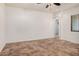 Open floor plan with neutral walls, tile flooring, a ceiling fan and a window at 13641 W Jesse Red Dr, Peoria, AZ 85383