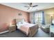 Comfortable bedroom with a ceiling fan, a neutral color scheme and natural light at 15613 W Minnezona Ave, Goodyear, AZ 85395