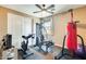 A well-equipped exercise room featuring modern equipment, a ceiling fan, and natural light at 15613 W Minnezona Ave, Goodyear, AZ 85395
