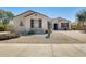 Charming single-story home with desert landscaping, brick driveway, and inviting front entrance at 15613 W Minnezona Ave, Goodyear, AZ 85395
