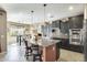 Modern kitchen with a center island, granite countertops, and stainless steel appliances at 15613 W Minnezona Ave, Goodyear, AZ 85395