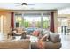 Comfortable living room showcasing a large window, neutral tones, and inviting furnishings at 15613 W Minnezona Ave, Goodyear, AZ 85395