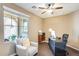 Bright office featuring a large window, ceiling fan, and stylish desk setup with a comfortable chair at 15613 W Minnezona Ave, Goodyear, AZ 85395