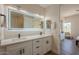Contemporary bathroom featuring double sink vanity with matte black hardware and backlit mirror at 16248 E Ridgeline Dr, Fountain Hills, AZ 85268