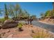 Gated community entrance features desert landscaping, mature trees and a clear blue sky at 16248 E Ridgeline Dr, Fountain Hills, AZ 85268
