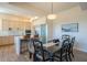 Dining room with modern light fixture adjacent to kitchen area and stainless refrigerator at 16248 E Ridgeline Dr, Fountain Hills, AZ 85268