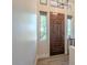 Inviting foyer features a rich wood front door, transom window, and stylish flooring at 16248 E Ridgeline Dr, Fountain Hills, AZ 85268