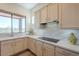 Bright kitchen with quartz counters, tiled backsplash, stainless steel appliances, and a window view at 16248 E Ridgeline Dr, Fountain Hills, AZ 85268