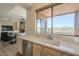 Kitchen sink with view of outdoor landscape, living room and fireplace at 16248 E Ridgeline Dr, Fountain Hills, AZ 85268
