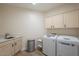 Bright laundry room equipped with a sink, countertops, and modern washer and dryer at 16248 E Ridgeline Dr, Fountain Hills, AZ 85268