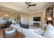 Bright living room featuring a comfortable sofa, fireplace, TV and seamlessly connects to the dining area and kitchen at 16248 E Ridgeline Dr, Fountain Hills, AZ 85268