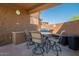 Covered outdoor kitchen featuring a built-in grill, dining table, and ample seating at 16248 E Ridgeline Dr, Fountain Hills, AZ 85268