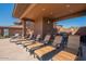 Covered patio area with lounge chairs, grill, sink, and ample space for relaxation and entertainment at 16248 E Ridgeline Dr, Fountain Hills, AZ 85268