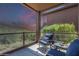 Relaxing covered patio featuring comfortable seating, glass railings, and picturesque desert views at 16248 E Ridgeline Dr, Fountain Hills, AZ 85268