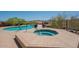 Relaxing outdoor pool and hot tub area surrounded by desert landscape and distant mountains at 16248 E Ridgeline Dr, Fountain Hills, AZ 85268