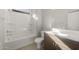 Spotless bathroom boasts a shower-tub combo, modern vanity, and abundant natural light at 17794 W Getty Dr, Goodyear, AZ 85338