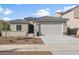 Charming single-story home features a two-car garage, desert landscaping, and a tile roof at 17794 W Getty Dr, Goodyear, AZ 85338