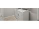 Well-lit laundry room featuring a side-by-side washer and dryer set against a light-colored wall at 17794 W Getty Dr, Goodyear, AZ 85338