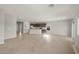 Spacious open-concept living room with tile floors, recessed lighting, and sliding glass door at 17794 W Getty Dr, Goodyear, AZ 85338