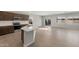 Open concept living space and kitchen area with tile flooring, stainless appliances and light gray walls at 17794 W Getty Dr, Goodyear, AZ 85338