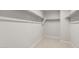 Empty walk-in closet with carpet and shelving at 17794 W Getty Dr, Goodyear, AZ 85338