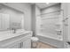 Bathroom featuring a vanity, toilet, and a tub/shower combo with a white surround at 17809 W Getty Dr, Goodyear, AZ 85338