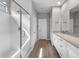 Bathroom showcasing a glass-enclosed shower and light wood-look tile flooring at 17809 W Getty Dr, Goodyear, AZ 85338