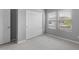 Carpeted bedroom with closet and natural light from two windows at 17809 W Getty Dr, Goodyear, AZ 85338