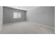 Spacious carpeted bedroom with window and neutral gray walls at 17809 W Getty Dr, Goodyear, AZ 85338