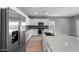 Modern kitchen featuring stainless steel appliances, sleek white cabinets, light countertops, and a stylish backsplash at 17809 W Getty Dr, Goodyear, AZ 85338