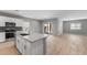 Open floor plan showcases a kitchen with island, stainless appliances, and sleek countertops, flowing into a living space at 17809 W Getty Dr, Goodyear, AZ 85338