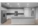 Bright, updated kitchen with white cabinets, stainless steel appliances, and a gray backsplash at 17812 W Getty Dr, Goodyear, AZ 85338
