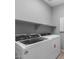 Laundry room with a Whirlpool washer and dryer set and a shelf above at 17812 W Getty Dr, Goodyear, AZ 85338
