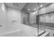 Beautiful glass-enclosed shower with built-in bench and subway tile, reflecting the vanity area at 17812 W Getty Dr, Goodyear, AZ 85338