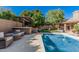 Inviting backyard pool and outdoor kitchen area perfect for entertaining with mature landscaping and privacy at 18036 N 49Th St, Scottsdale, AZ 85254