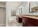 Large bathroom with double vanity, granite counters, and a tub shower at 18036 N 49Th St, Scottsdale, AZ 85254