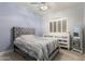 Charming bedroom with tufted headboard, dresser, and a window at 18036 N 49Th St, Scottsdale, AZ 85254