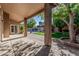 Covered patio offers a relaxing view of a beautiful backyard pool, lawn, and mature trees at 18036 N 49Th St, Scottsdale, AZ 85254