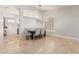 Open dining room with travertine flooring, modern light fixture, and views into the living area at 18036 N 49Th St, Scottsdale, AZ 85254