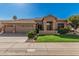 Charming single-story home featuring a three-car garage, well-maintained landscaping, and a neutral-toned exterior at 18036 N 49Th St, Scottsdale, AZ 85254