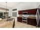 Kitchen with stainless steel appliances, stone countertops, island with breakfast bar, and backyard access at 18036 N 49Th St, Scottsdale, AZ 85254