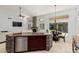 Kitchen featuring stone-wrapped island with breakfast bar, stone fireplace, and views to the backyard at 18036 N 49Th St, Scottsdale, AZ 85254